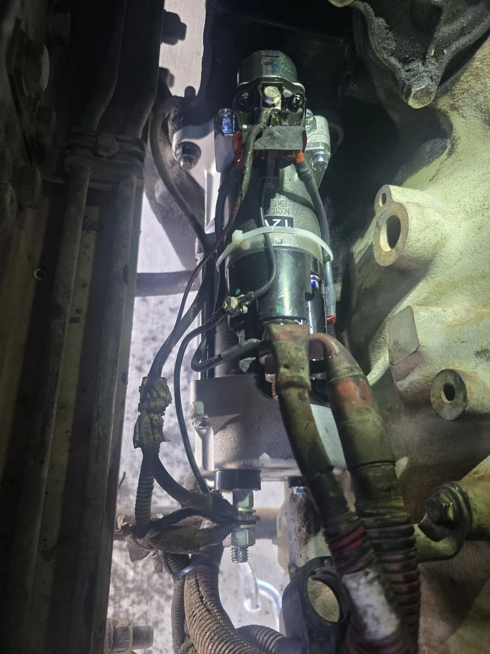 New starter motor installed on the semi truck engine