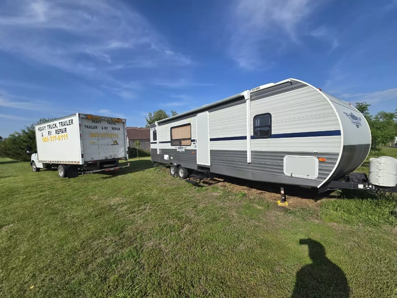 A&A Heavy Duty Repair & Towing service truck parked beside a Shasta camper trailer for on-site service