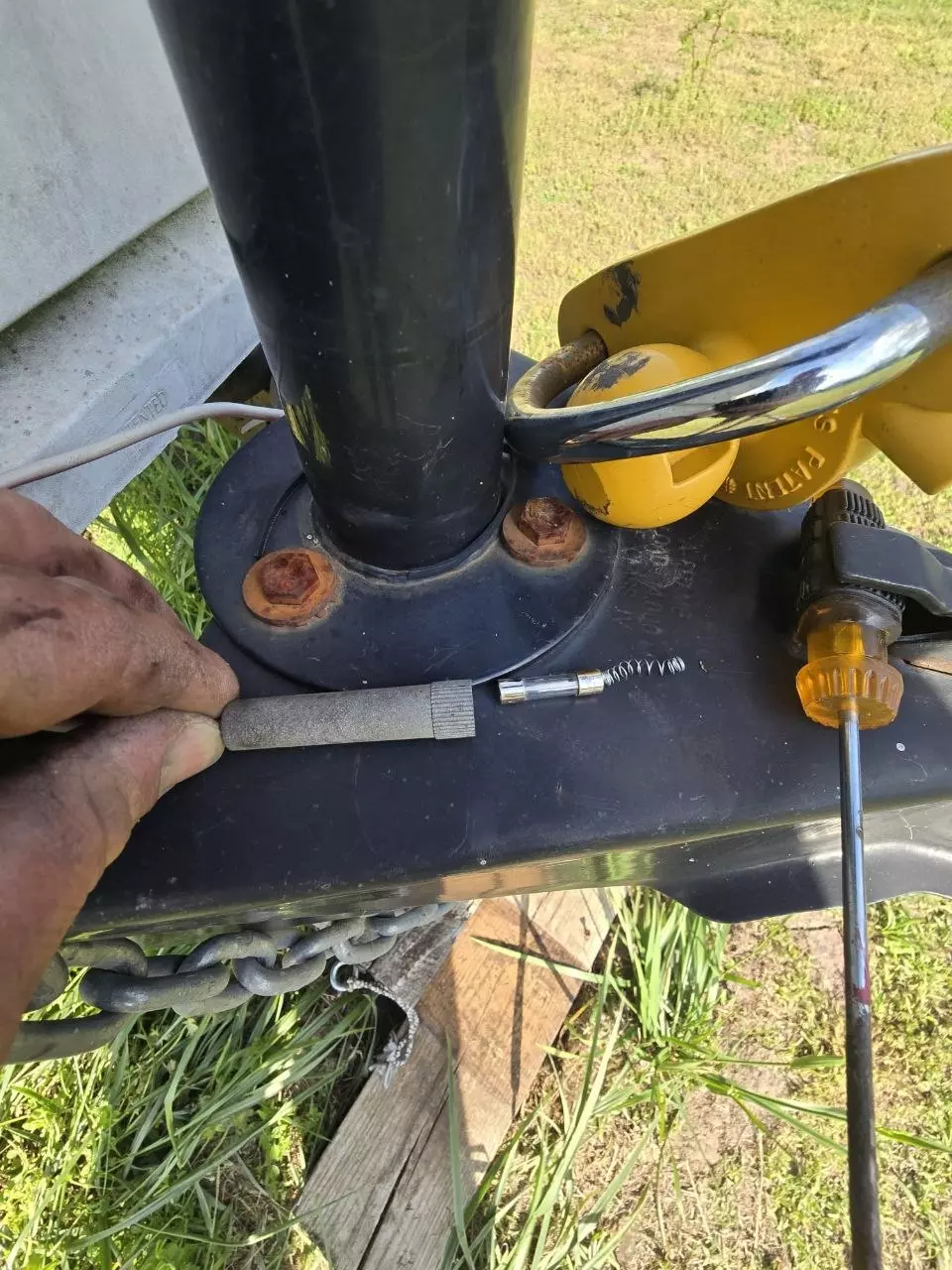 Close-up of the camper trailer's front jack during wiring and fuse repair