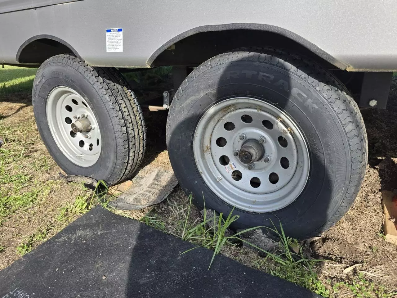 Underneath the camper trailer during tire and jack service