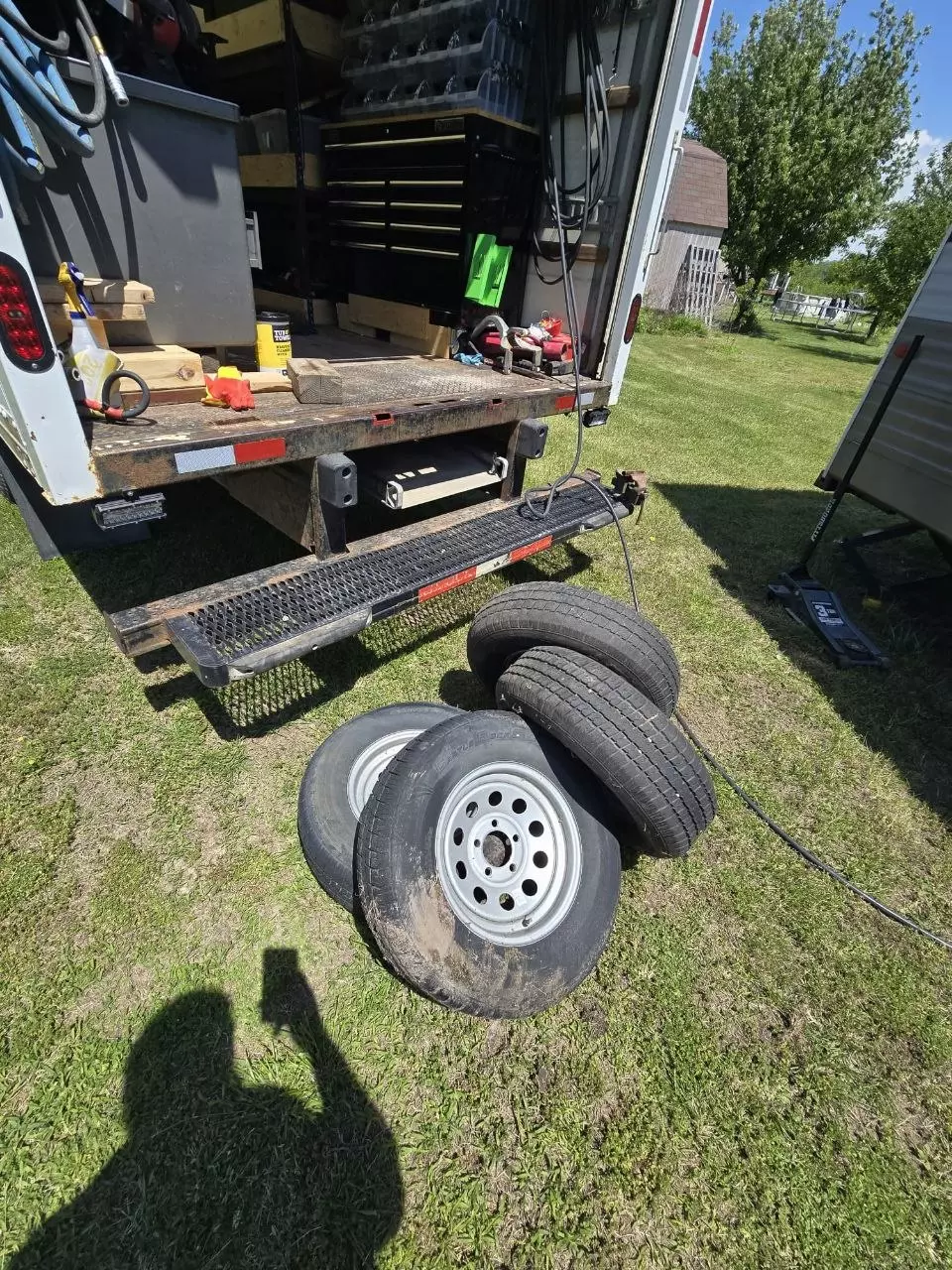 Old dry-rotted tires removed and set beside the service van